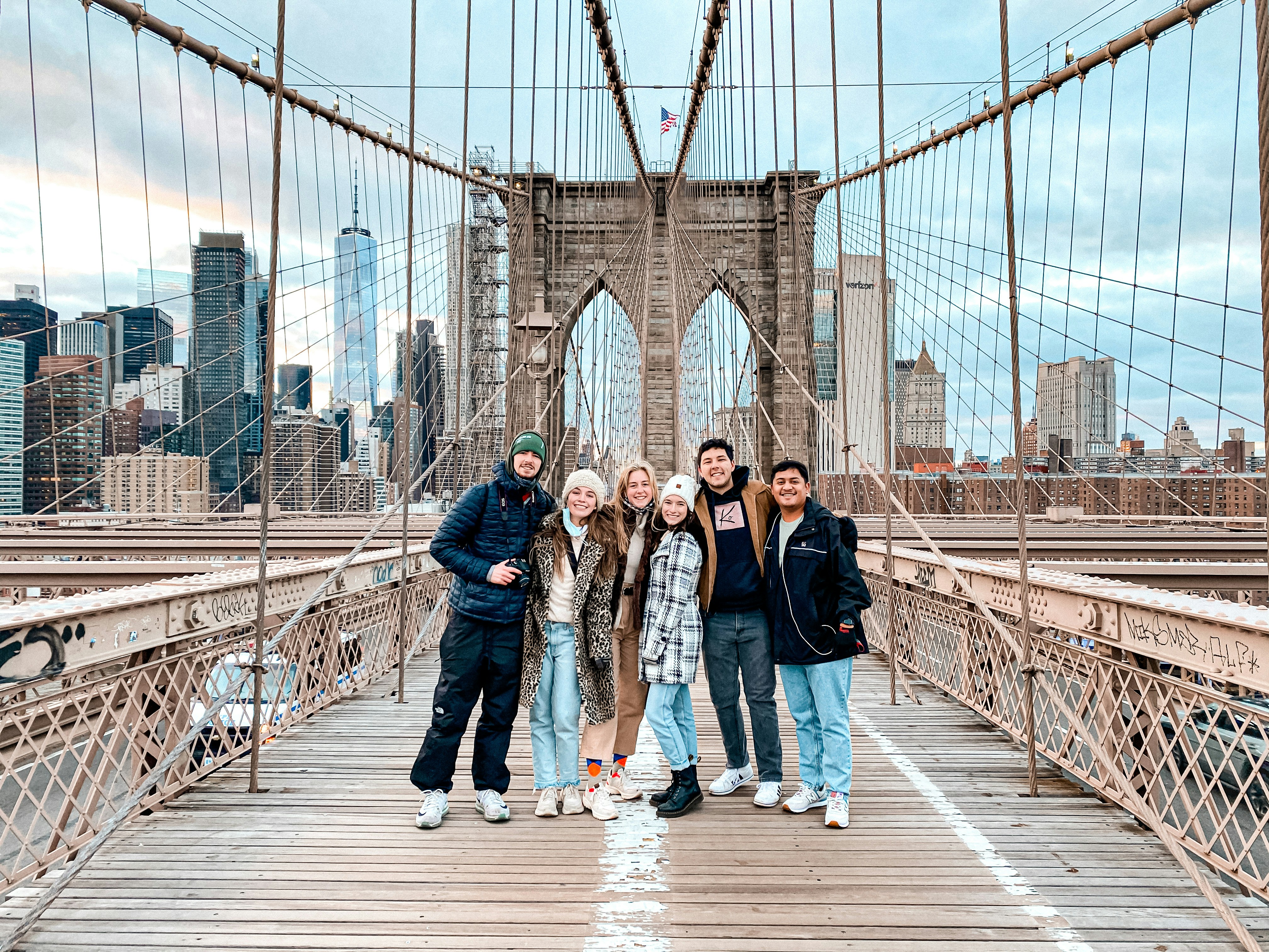 3 women standing on bridge during daytime