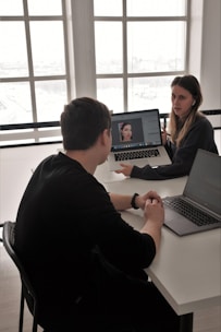 man in black long sleeve shirt using macbook pro