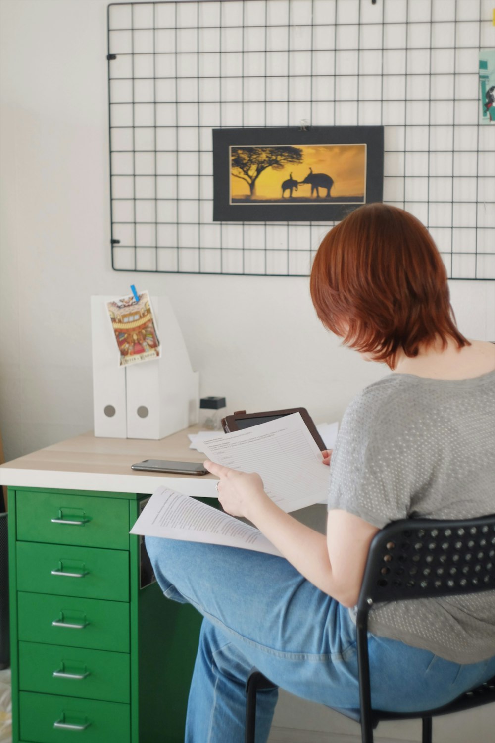 woman in gray shirt sitting on chair