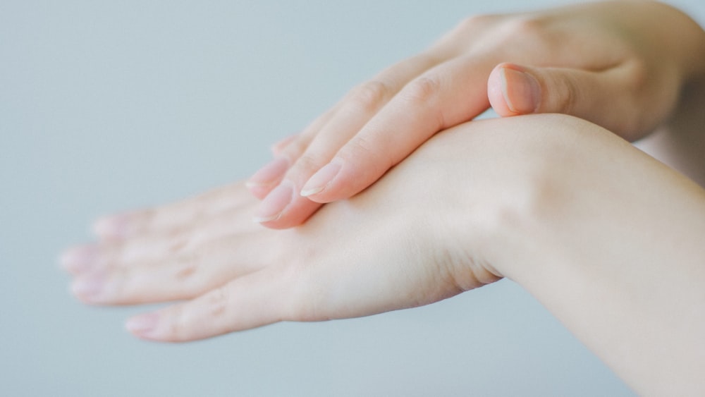 persons hand holding babys hand