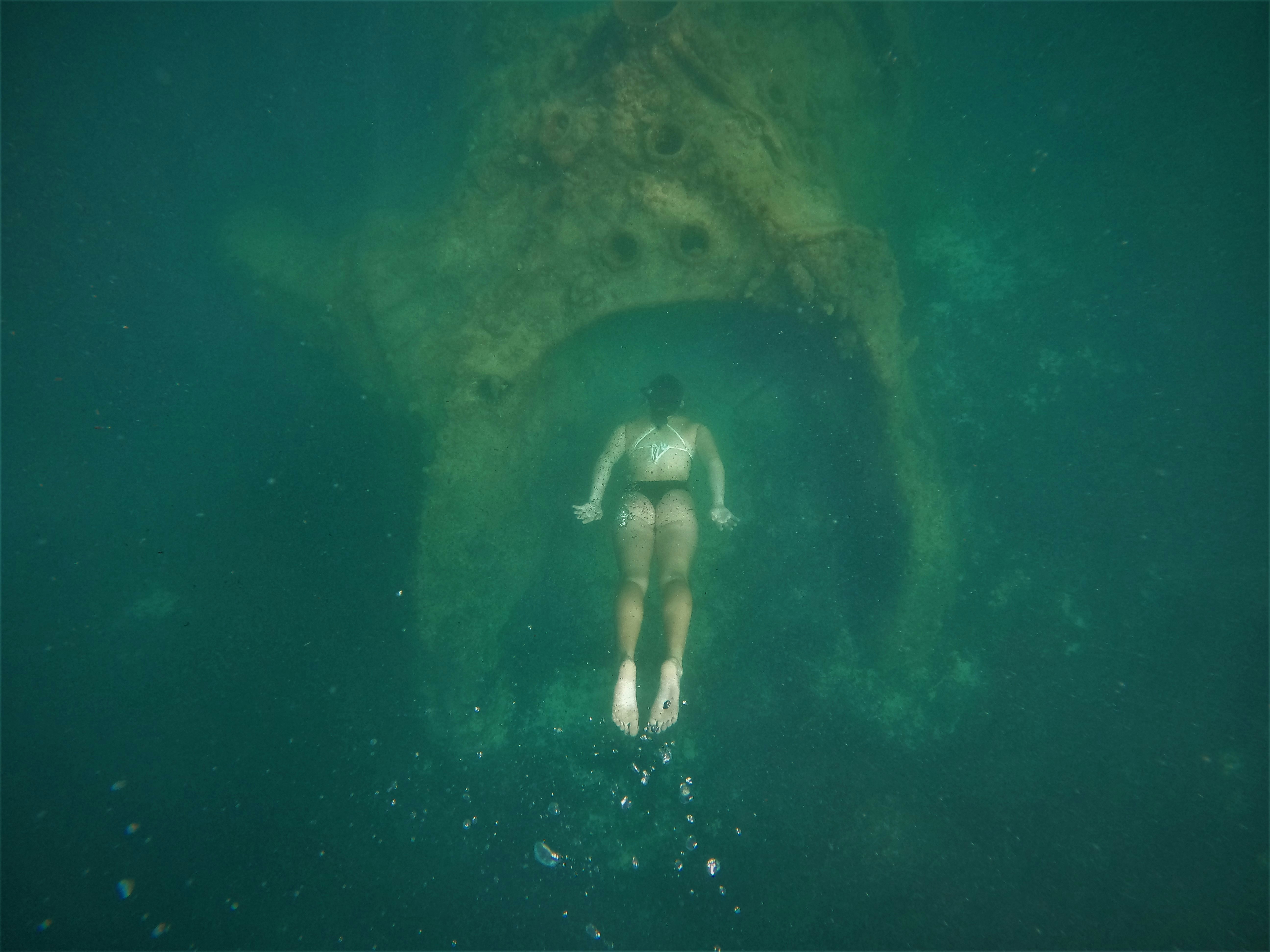 woman in white bikini swimming in the water