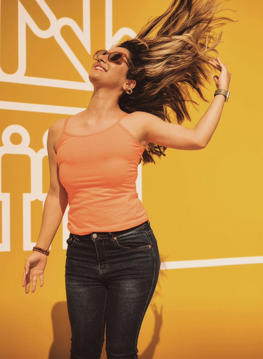 woman in pink tank top and blue denim jeans