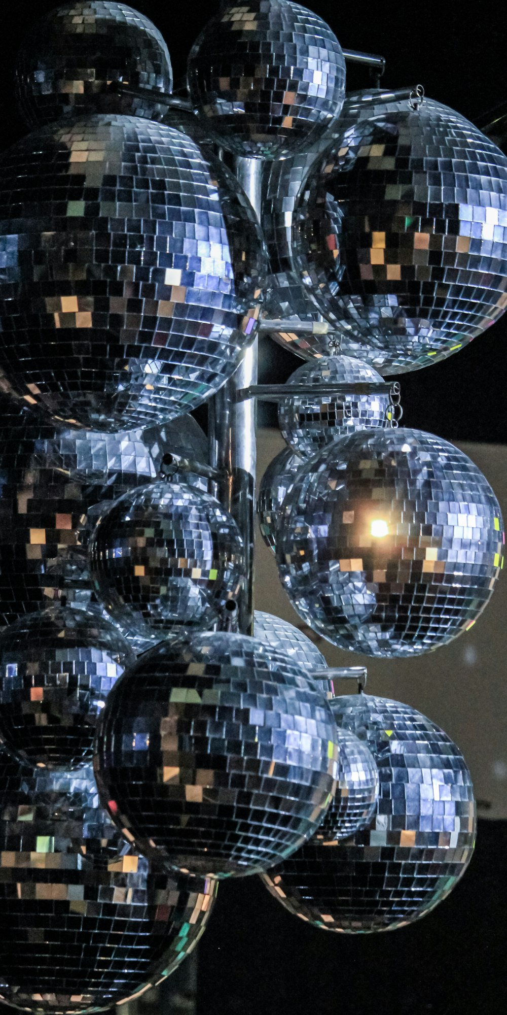 silver round ball ornament on black table