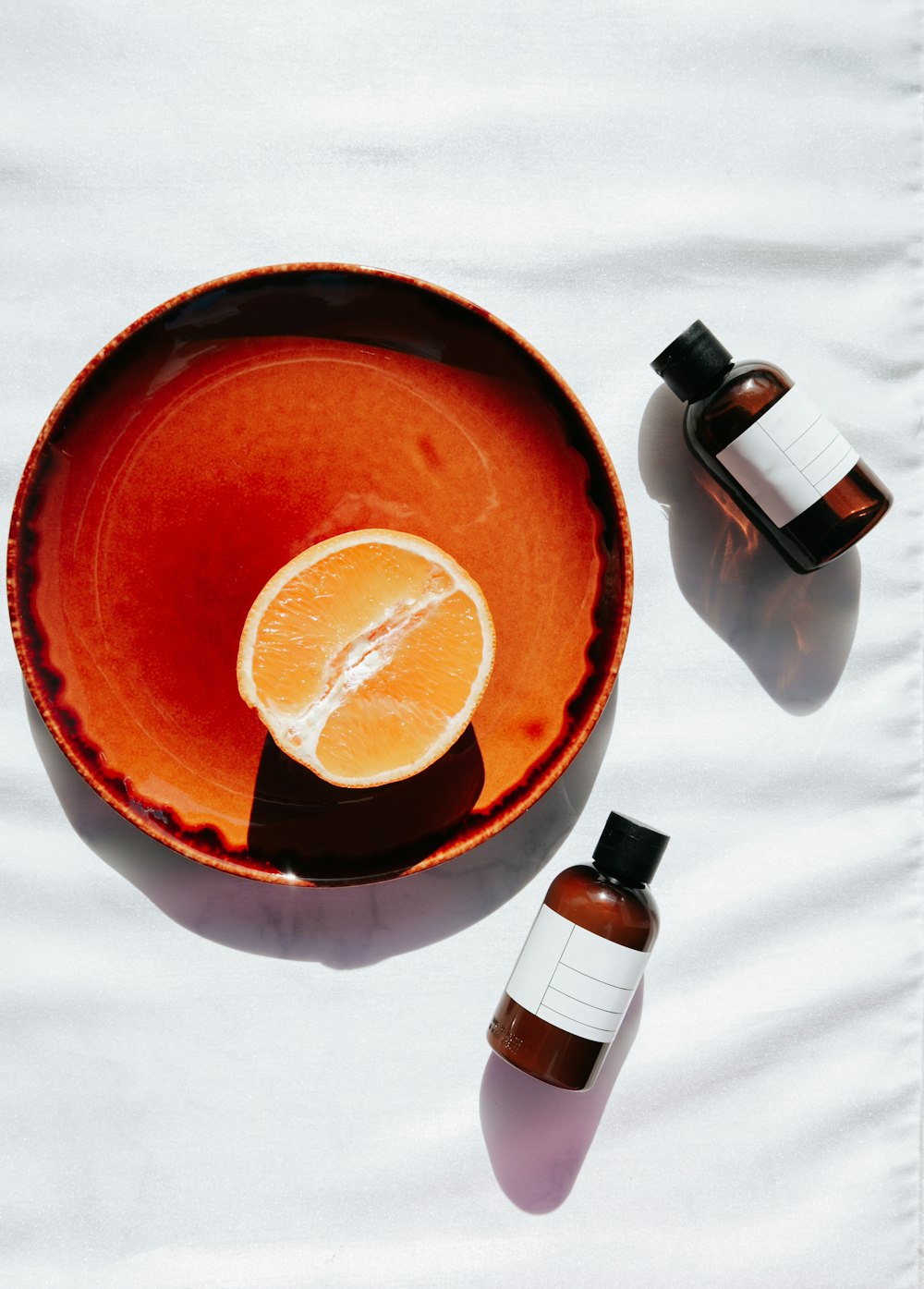 sliced orange fruit on red ceramic bowl