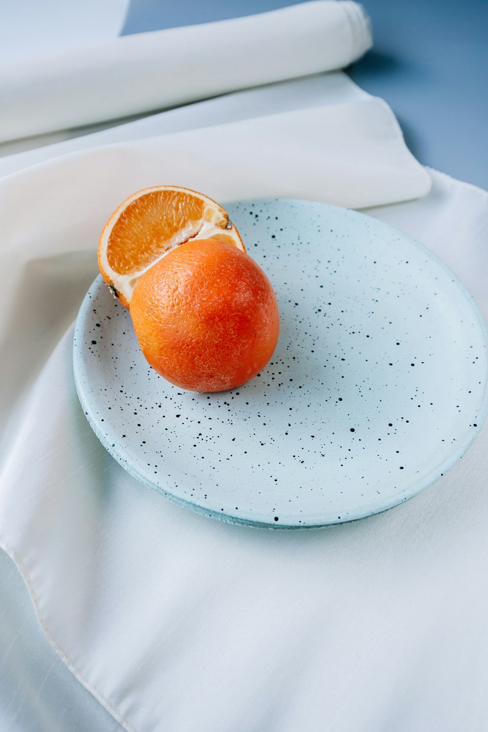 orange fruit on white ceramic plate