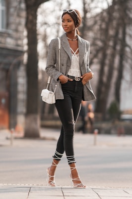 woman in gray blazer and black pants holding white ceramic mug