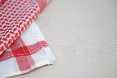 white and red checkered textile napkin teams background