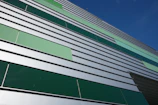 Exterior wall cladding with eco-friendly panels on a commercial building.
