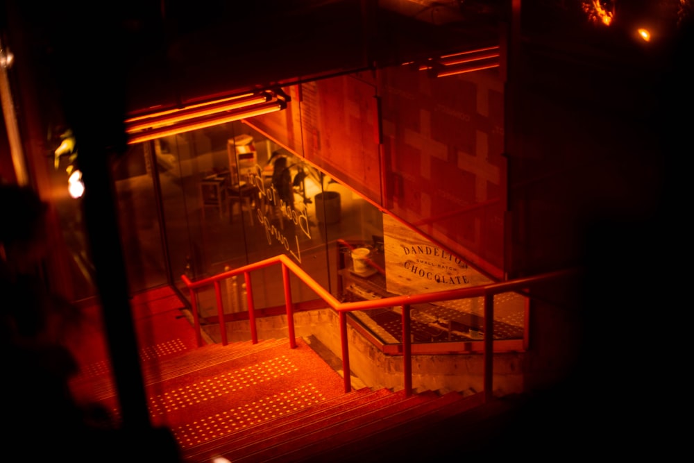 red metal staircase near brown brick wall