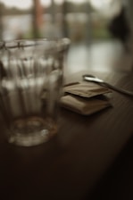 Close-up of a spoonful of white stevia sweetener crystals on a wooden table.