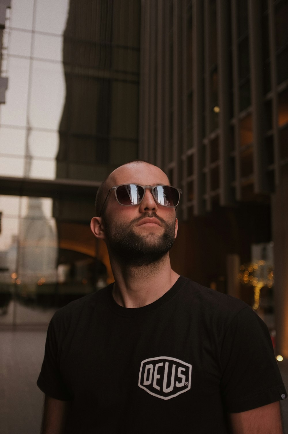 man in black crew neck shirt wearing sunglasses