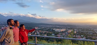 A cheerful family of four enjoying a scenic view of Bandung hills during a private tour