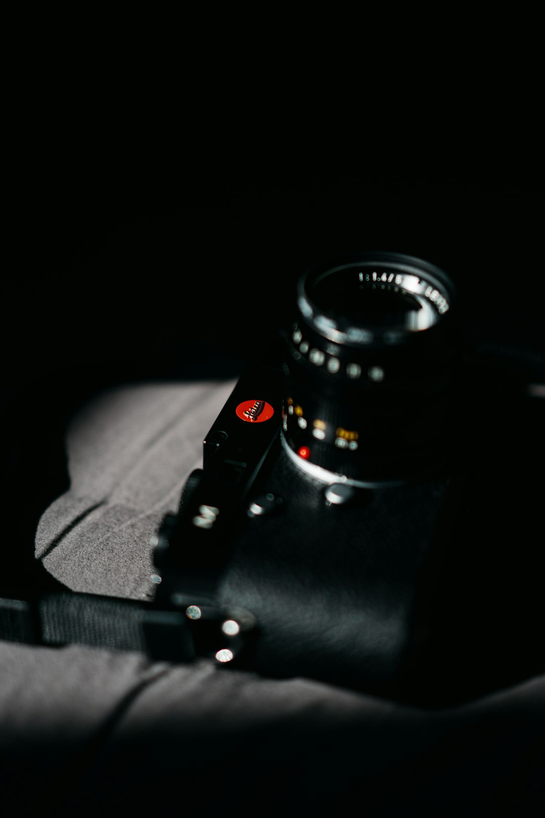 black dslr camera on white textile
