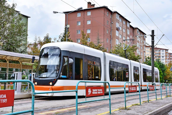 red and white train on rail road during daytime