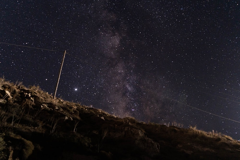 white wind turbine under starry night