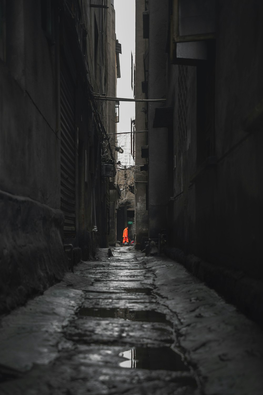 person in red jacket walking on street during daytime