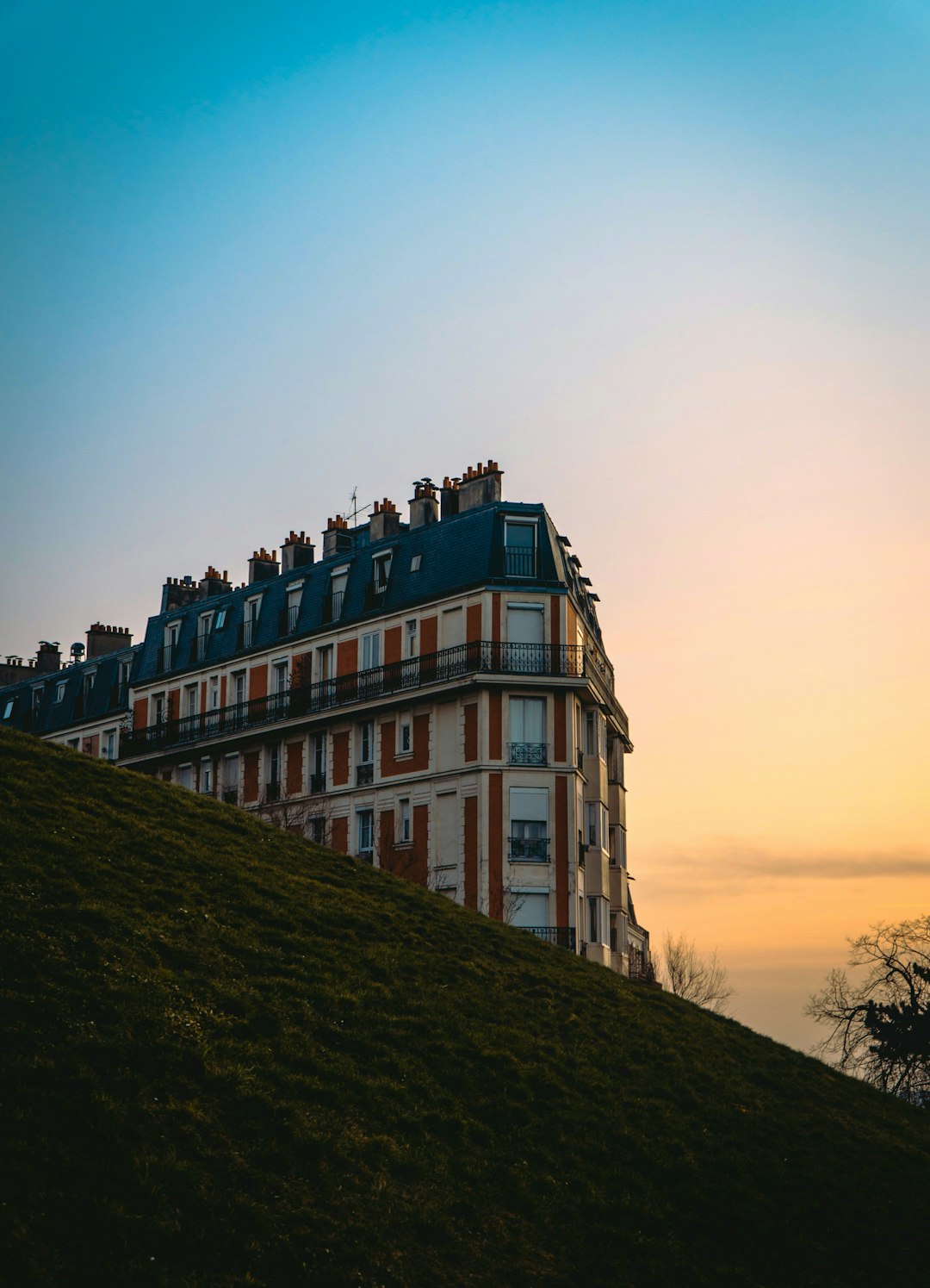 brown concrete building on hill during sunset