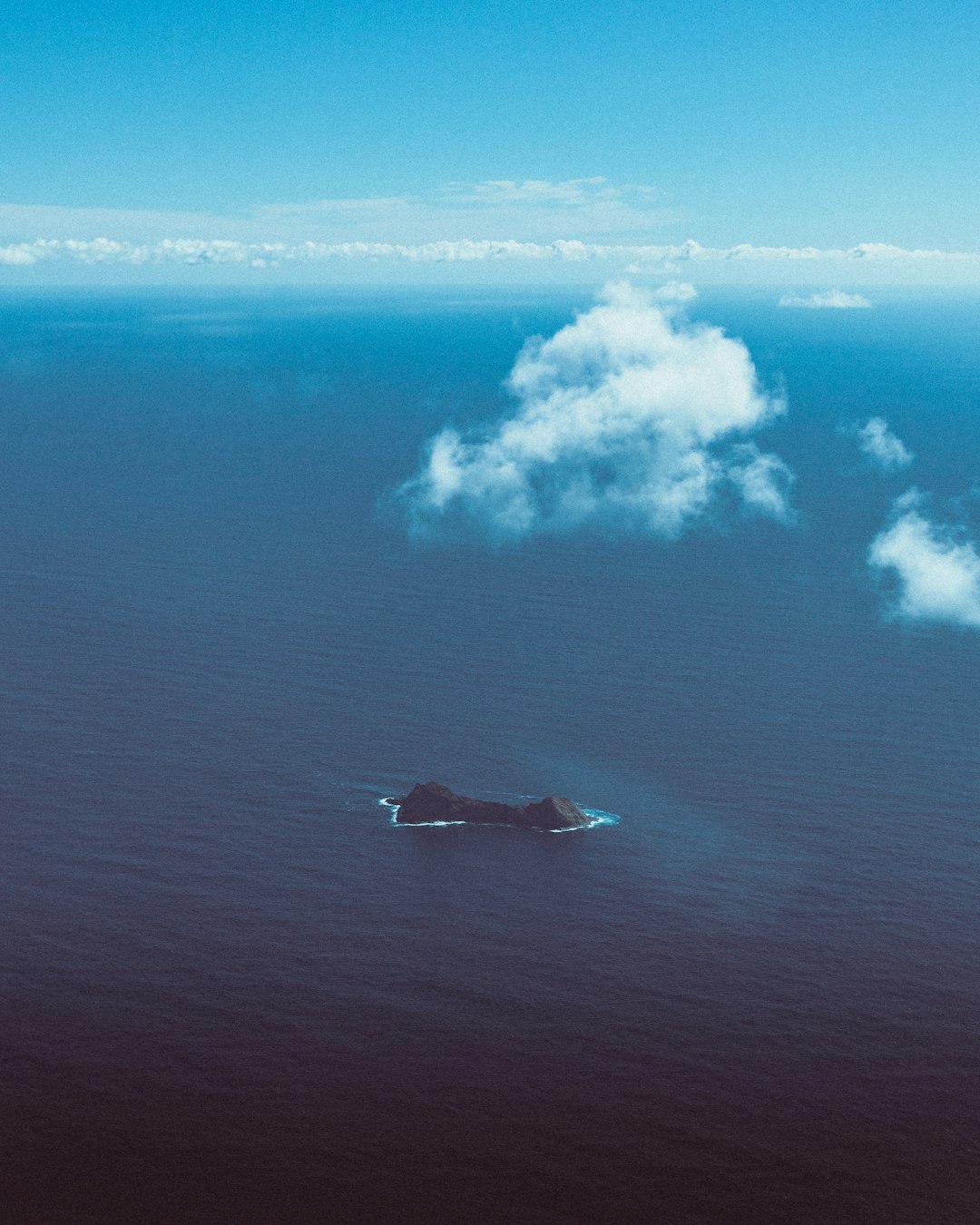 white and blue sky over sea