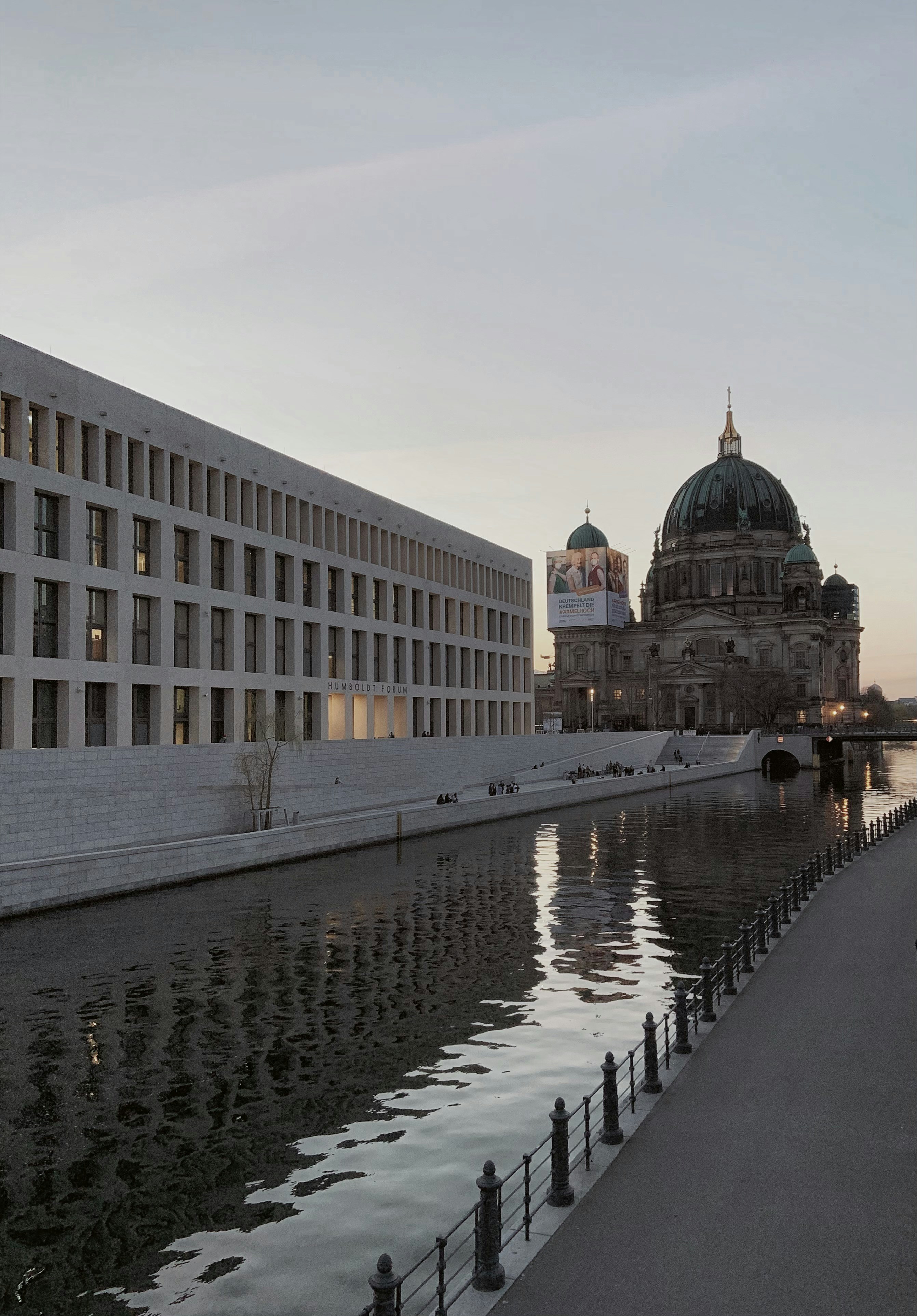 white concrete building near body of water during daytime