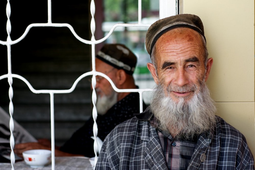 man in black and white plaid button up shirt wearing brown hat