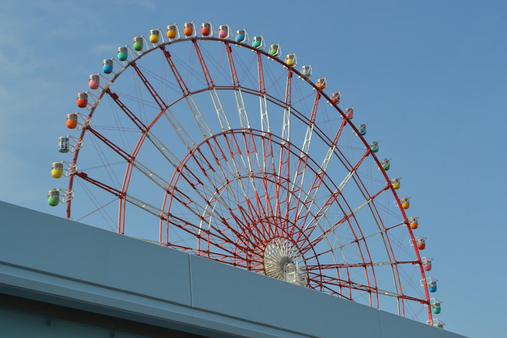 white and red ferris wheel under blue sky during daytime