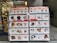 A display stand showcasing various 2020 calendars featuring different animal themes, primarily dogs, cats, and pigs. The calendars are organized in a grid format with clear images of adorable animal faces on their covers. This stand is located in front of a shop interior with bags and other merchandise visible.