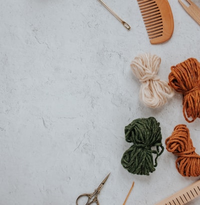 orange and white yarn on white table