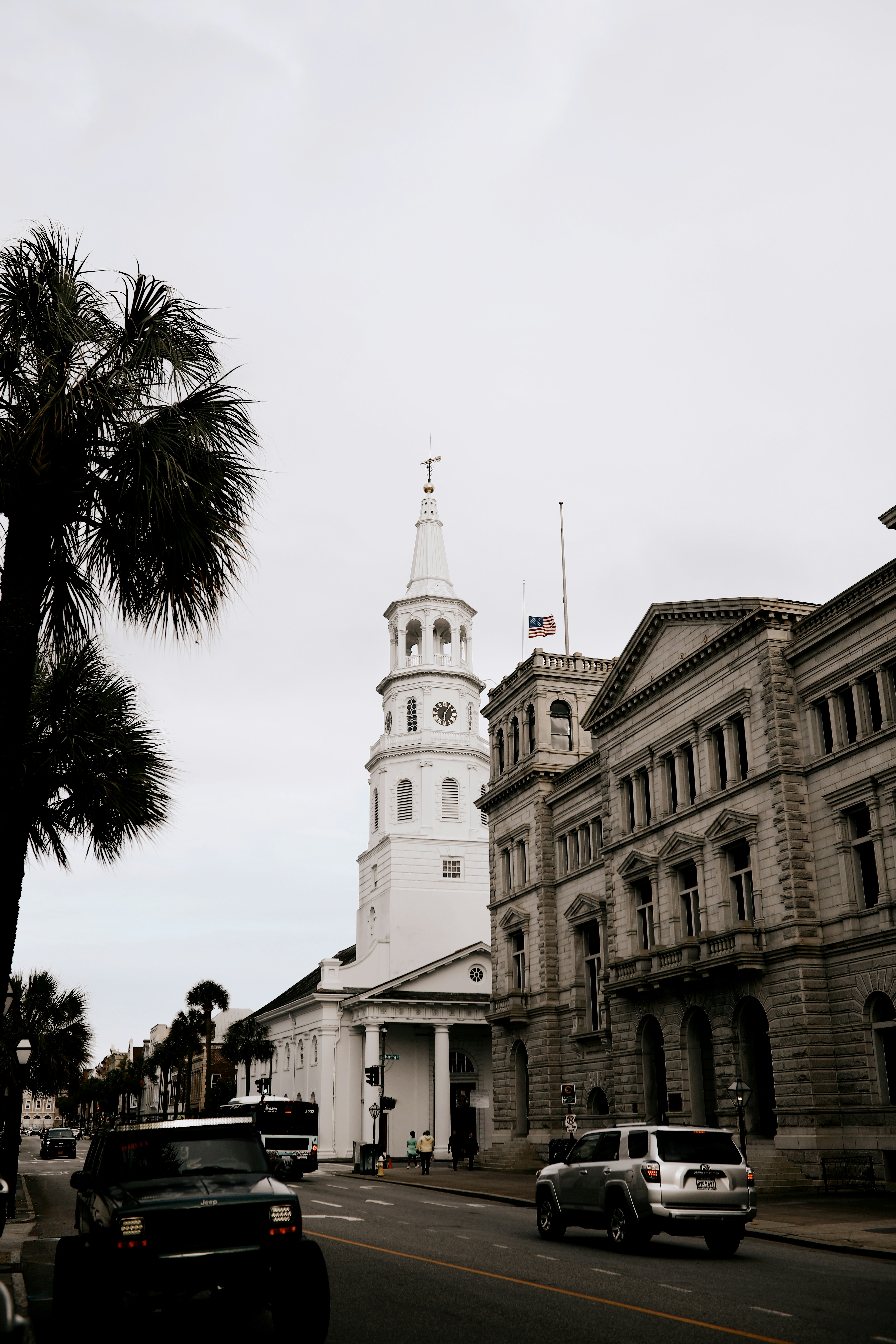 white concrete building near palm trees during daytime
