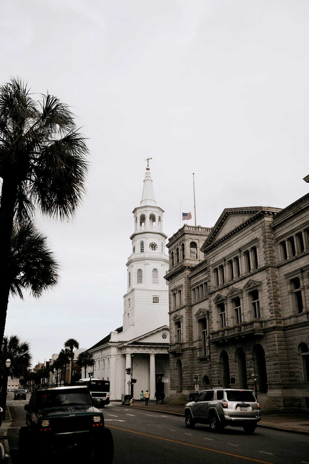 white concrete building near palm trees during daytime