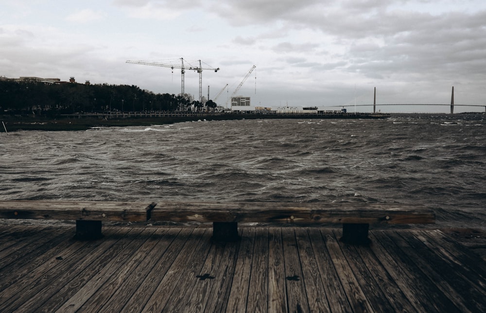 brown wooden dock on body of water during daytime