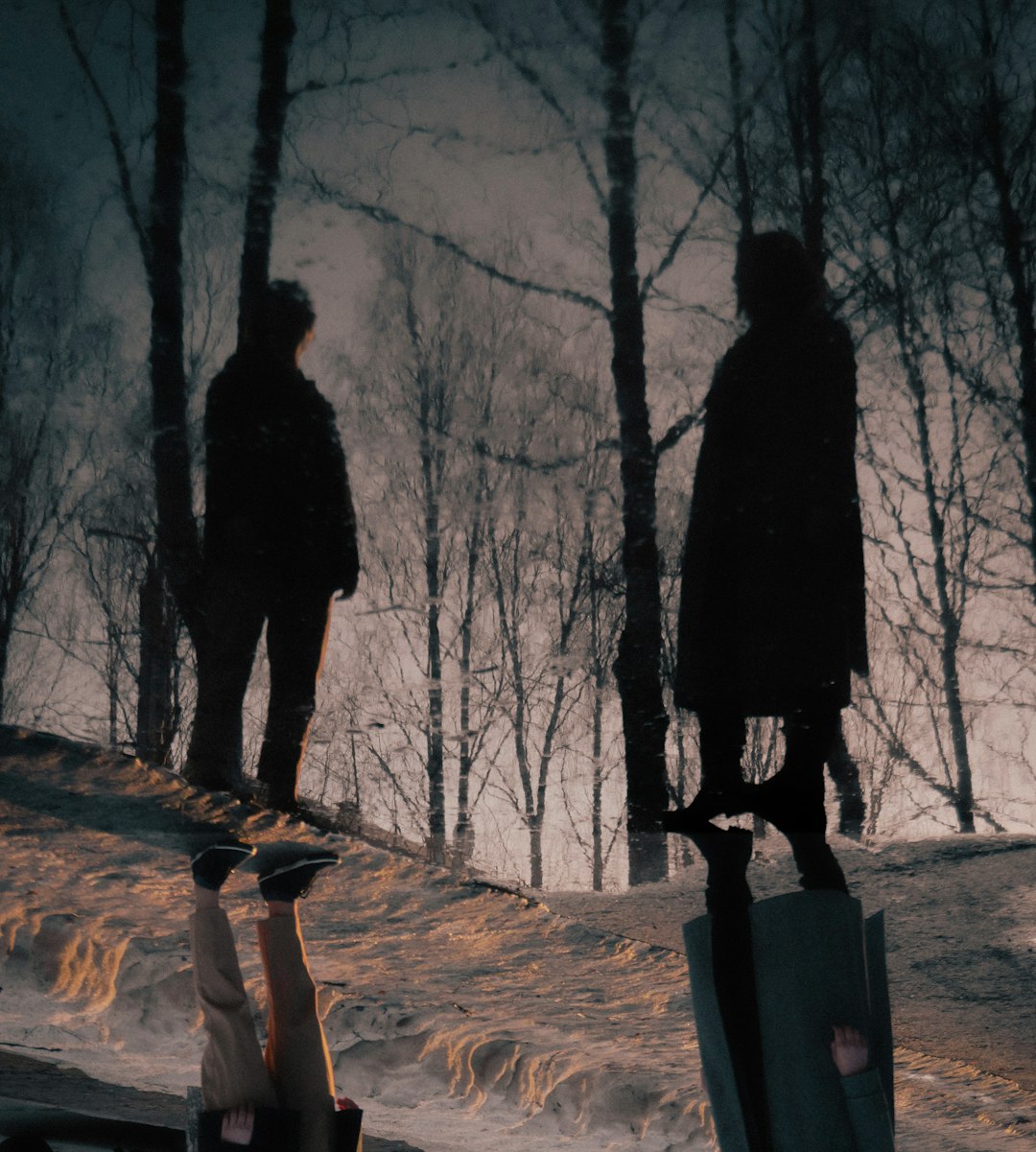 man and woman standing on brown dirt road during daytime