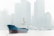 A cargo ship with a blue and red hull sails along a river, framed against the backdrop of a city skyline filled with tall, modern skyscrapers shrouded in mist or fog. The scene appears calm with the water reflecting the overcast sky.