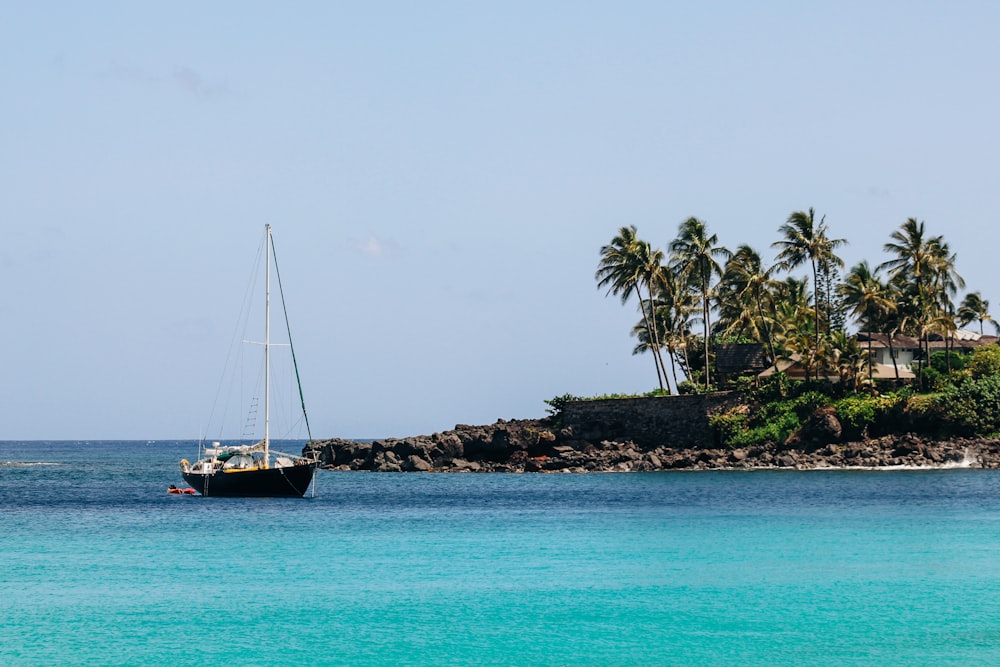 white sail boat on sea during daytime