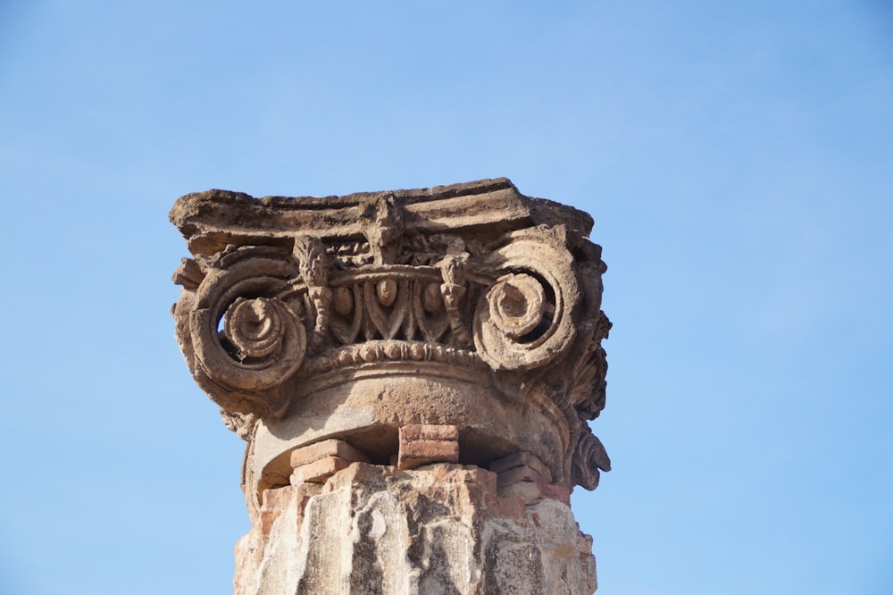 brown concrete statue under blue sky during daytime