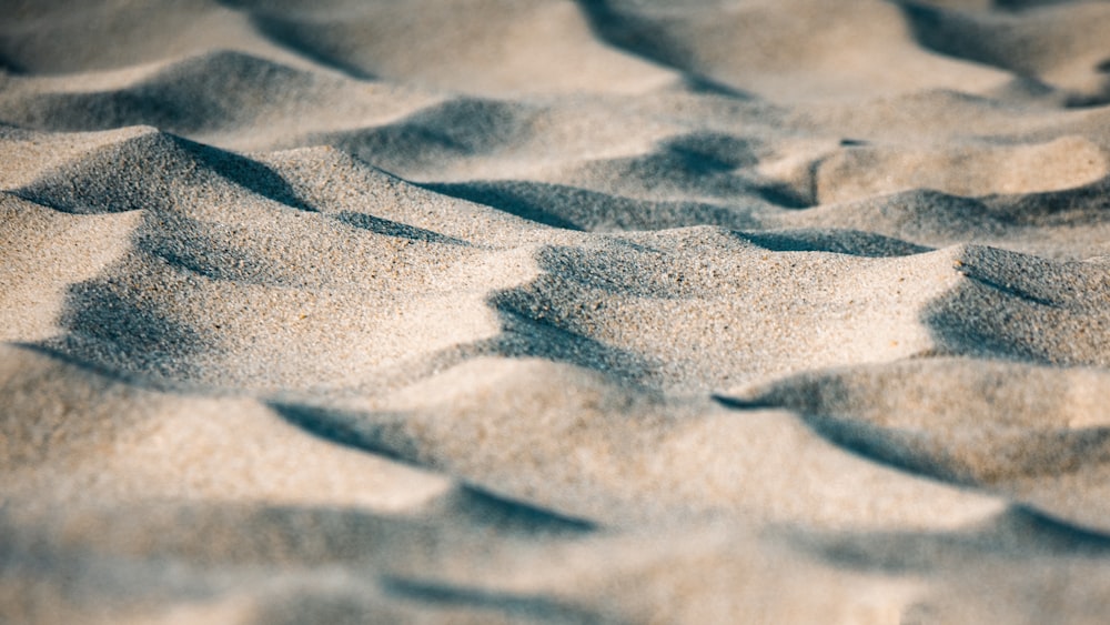 brown sand with footprints during daytime