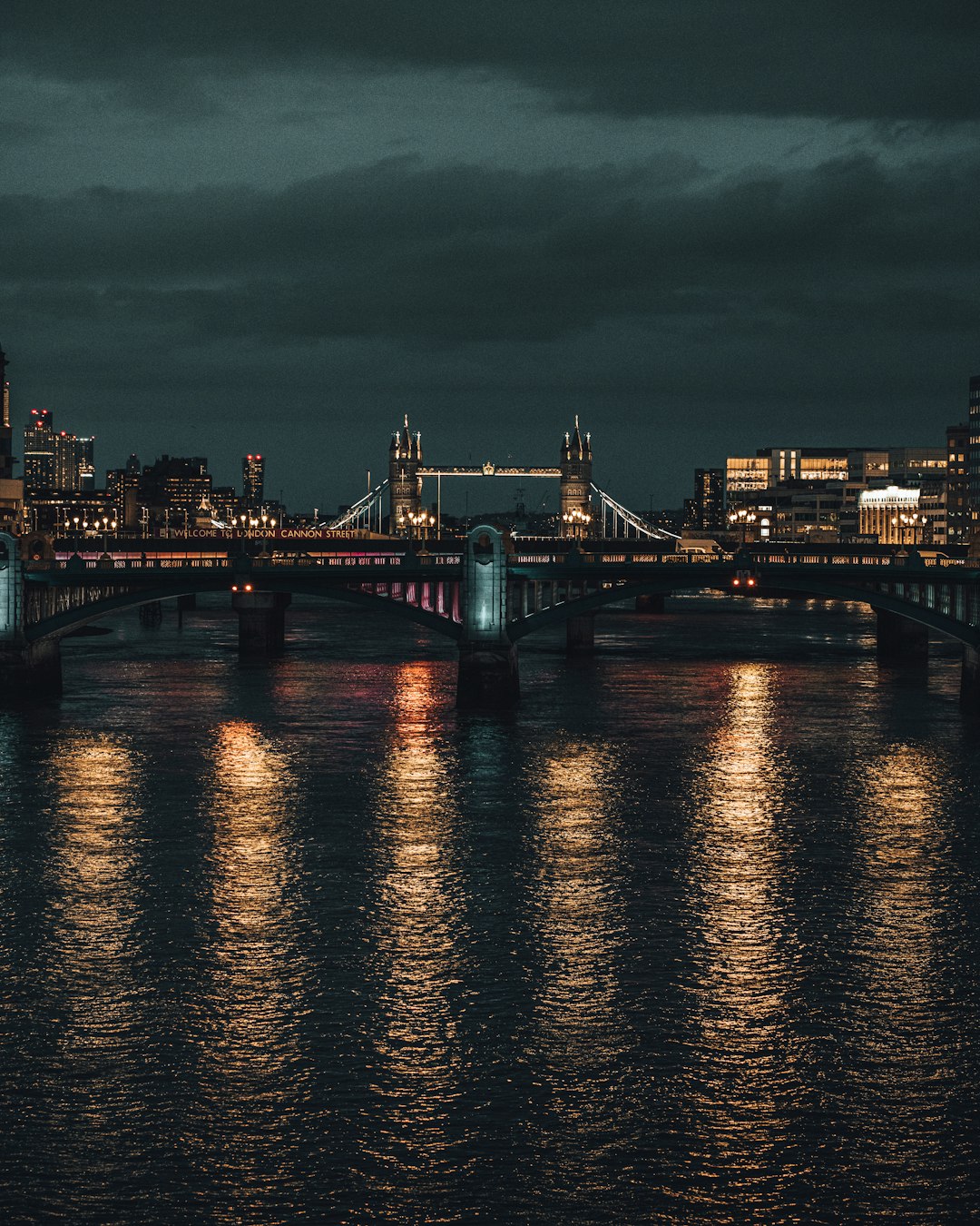 bridge over body of water during night time