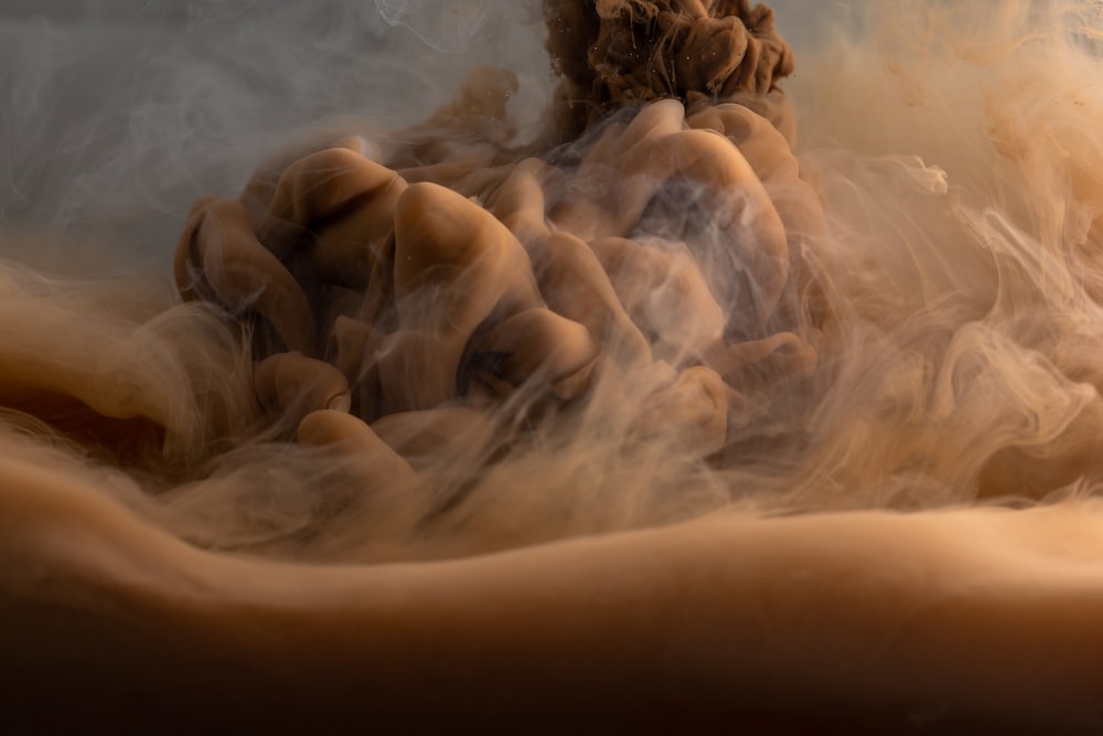 brown rock formation with white clouds