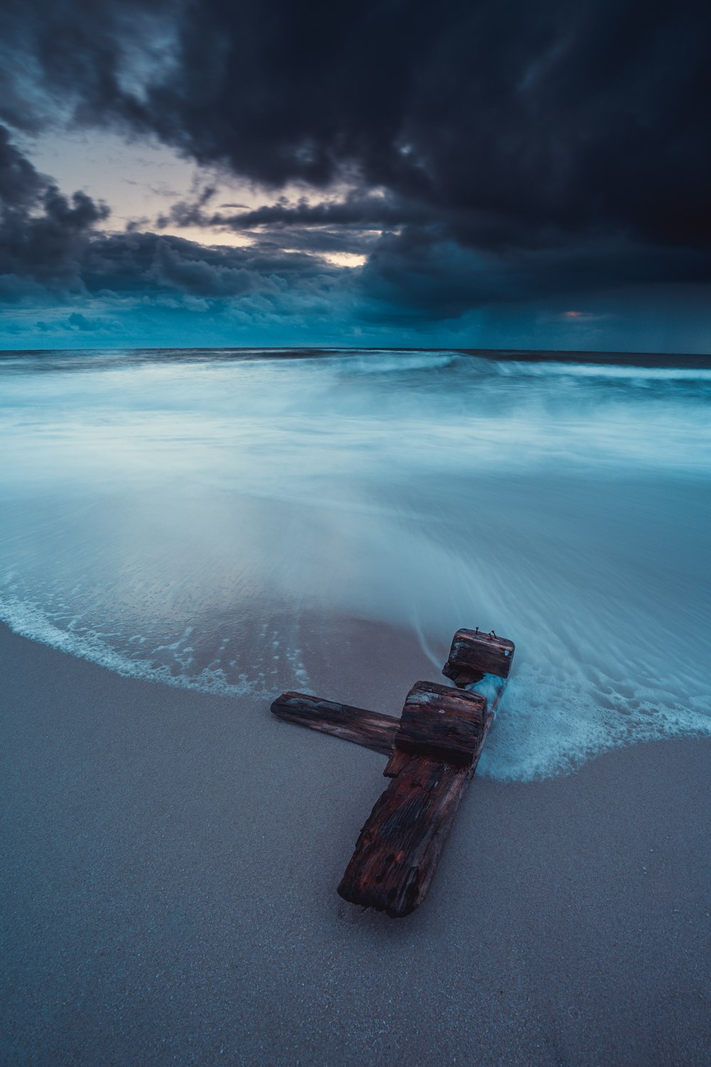 brown wooden post on sea shore during daytime