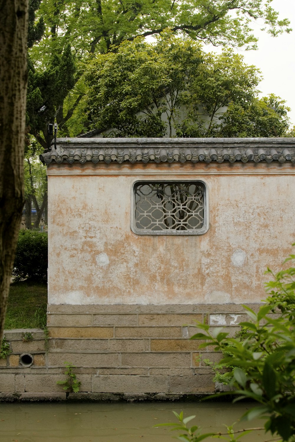 brown concrete building with black metal window frame