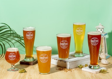 three clear drinking glasses on brown wooden table