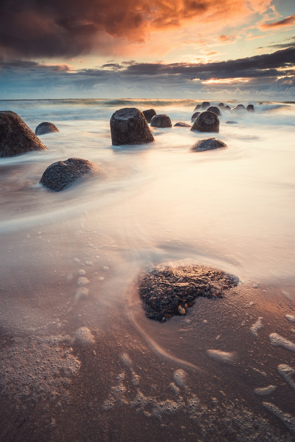 brown rock formation on body of water during daytime