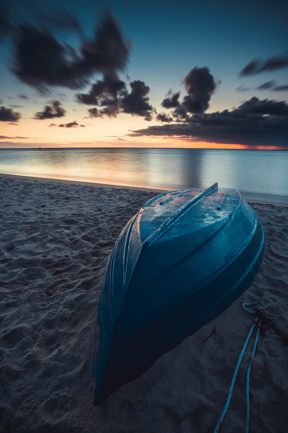 blue and white tent on beach during sunset