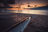Sunset view from a catamaran sailing near lush Martinique coastline