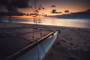 Sunset view from a catamaran sailing near lush Martinique coastline
