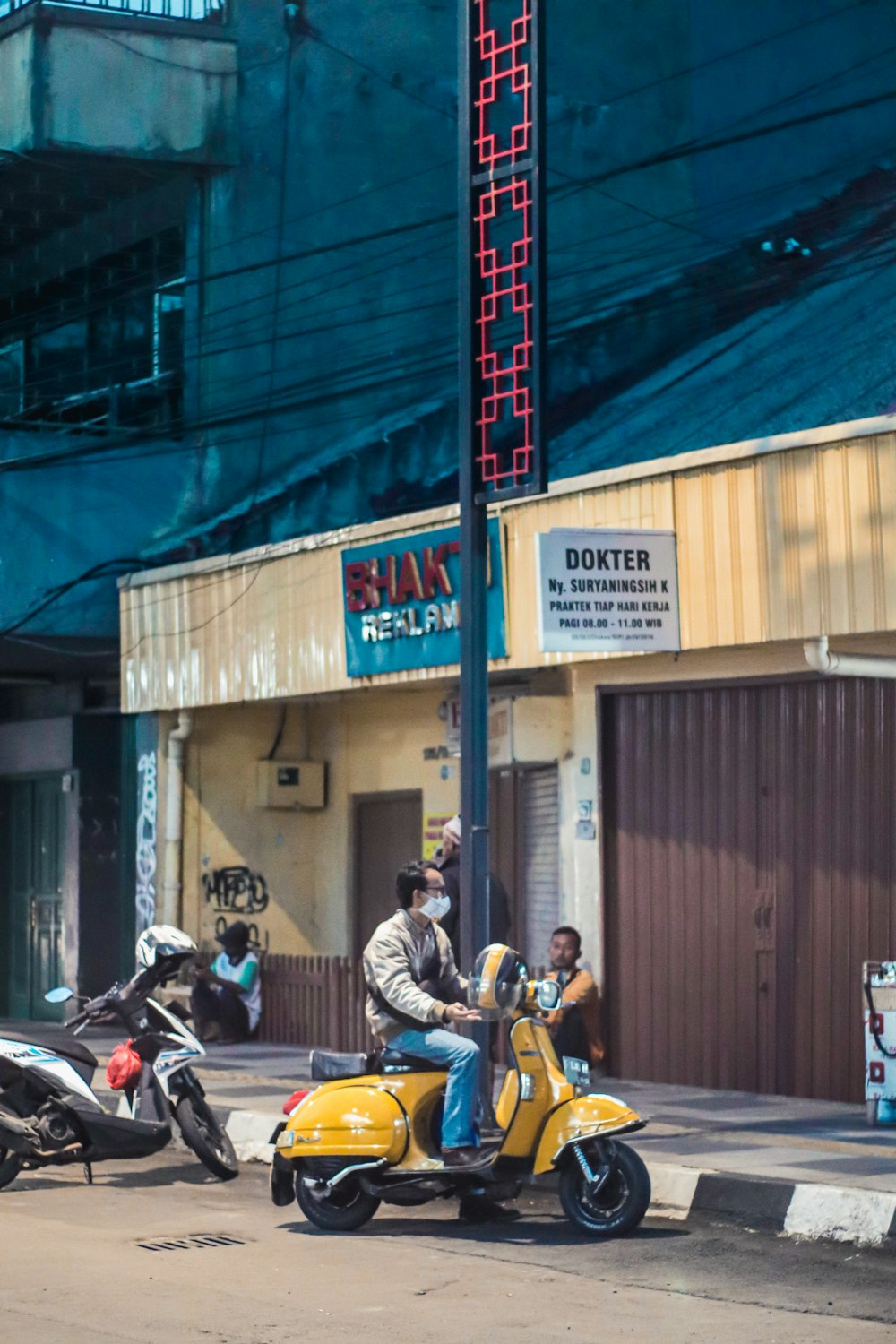 man in yellow shirt riding motorcycle