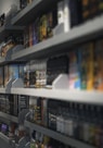 woman in black shirt standing in front of store shelf