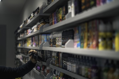 man in black long sleeve shirt holding black dslr camera