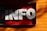 Large three-dimensional white letters spelling 'INFO' are mounted on a contrasting bright red background. The structure is attached to a wall with wooden planks painted in a vivid orange color, and gentle shadows are cast across the surface.