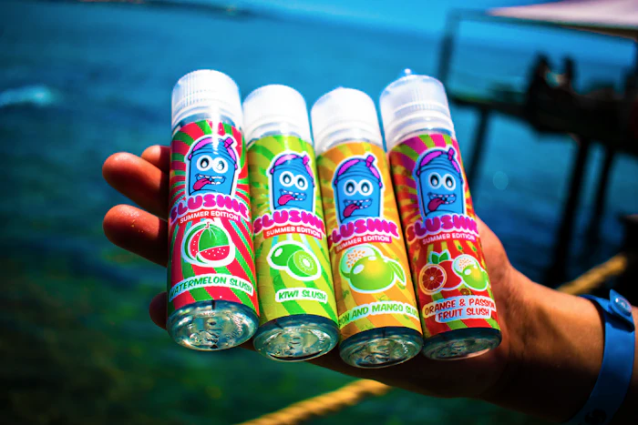 Three colourful labelled e-liquid bottles on display