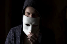 person in black knit cap and gray sweater